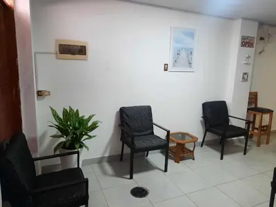 a waiting room with chairs and a potted plant at Hospedaje Kaihalulu in Punta Hermosa