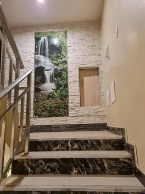 a staircase with a painting on the wall at Hostal Tuki Huancayo in Huancayo