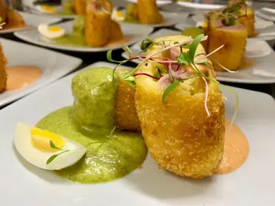 a plate of food on a table with food at Hotel Sol de Ica in Ica