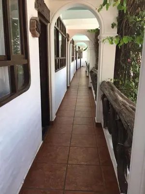 an empty hallway of a house with an archway at Hotel Sol de Ica in Ica
