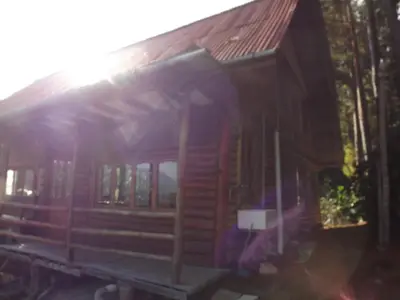 a wooden train car sitting on the tracks at La Casita de Oxapampa in Oxapampa