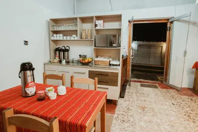 a kitchen with a table and a kitchen with a kitchen gmaxwell gmaxwell gmaxwell at Cochito Cusco in Cusco