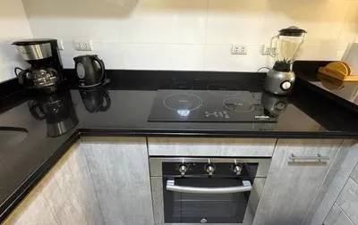 a kitchen with a stove and a blender on a counter at Loft Central Miraflores in Lima