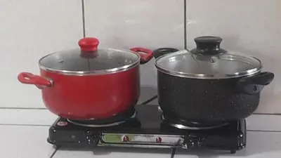 a red pot sitting on top of a stove at 101 Comfy Apt WiFi kitchen SmartTV Central at Callao in Lima