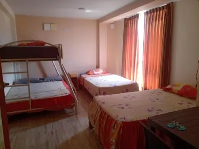 a bedroom with two bunk beds and a window at Estancia Saraja in Ica