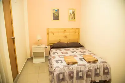 a small bedroom with a bed with two towels on it at Estancia Saraja in Ica