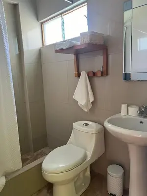 a bathroom with a toilet and a sink at RESORT ALAPA in Huancayo