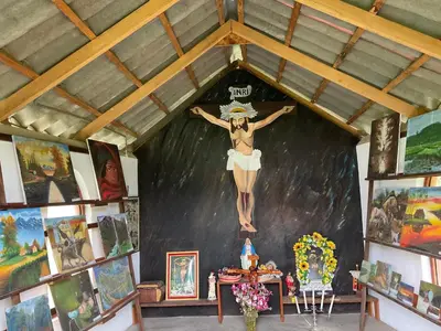 a painting of a woman on a wall in a room with paintings at RESORT ALAPA in Huancayo