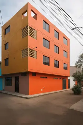 a building with an orange at 402 Comfy Apt WiFi kitchen SmartTV Central at Callao in Lima