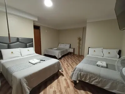 a hotel room with two beds and a room with at HOTEL MAR Y LAGO in Lunahuaná