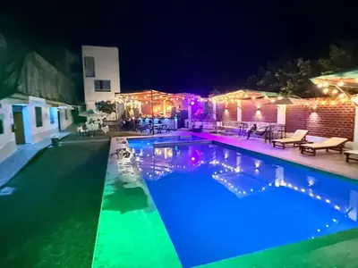 a swimming pool lit up at night with lights at HOTEL MAR Y LAGO in Lunahuaná