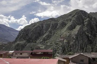 a mountain with a village in front of it at Doña Catta Casa Boutique in Ollantaytambo