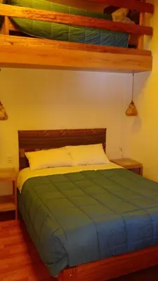 a bedroom with a bed and two bunk beds at B&B Chayana Wasi in Ollantaytambo