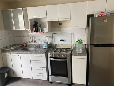 a kitchen with a stove and a refrigerator at Miraflores - Luxury Room in the Best Place in Lima