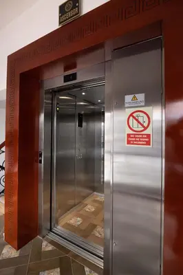 an elevator in a building with a sign on it at Hotel Hacienda Cusco Centro Historico in Cusco