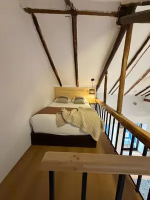 a bed in the middle of a room at CASA CRISTOBAL Siete Cuartones in Cusco