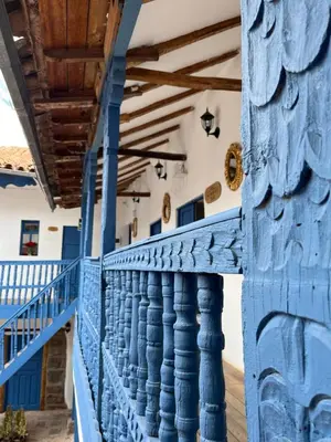 a blue balcony of a house with blue columns at CASA CRISTOBAL Siete Cuartones in Cusco