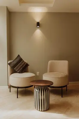 a room with two chairs and a coffee table at Kokoa Hotel Cusco in Cusco