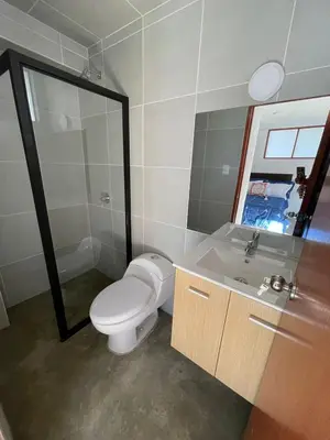 a bathroom with a toilet and a sink and a mirror at CasaHotel Laguna Jauja Airport in Jauja