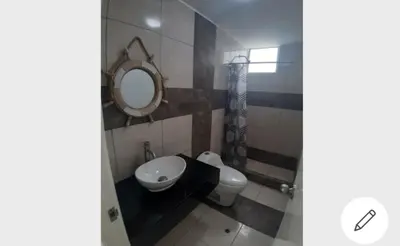 a bathroom with a toilet and a sink and a mirror at Depa de Playa en Asia in Asia