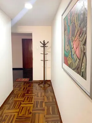 a room with a cross on the wall and a painting at Lindo departamento en Magdalena del Mar in Lima
