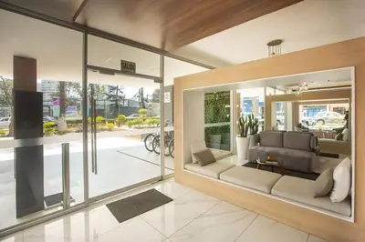 a living room with a couch and some windows at Grau by Wynwood House in Lima