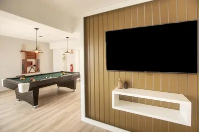 a living room with a pool table and a flat screen tv at Grau by Wynwood House in Lima