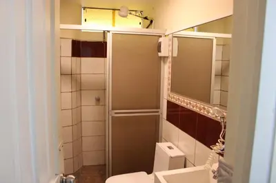 a small bathroom with a shower and a toilet at Hospedaje San Isidro 402 in Lima