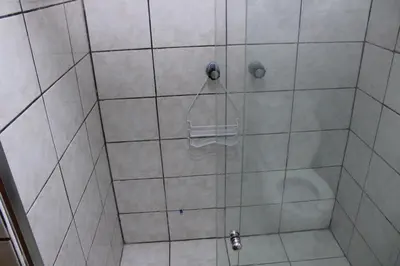 a shower with a glass door with a toilet at Hospedaje San Isidro 402 in Lima