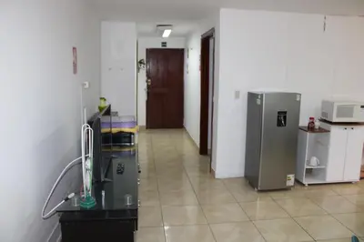 a room with a kitchen with a refrigerator at Hospedaje San Isidro 402 in Lima