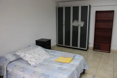 a bedroom with a bed with a yellow towel on it at Hospedaje San Isidro 402 in Lima
