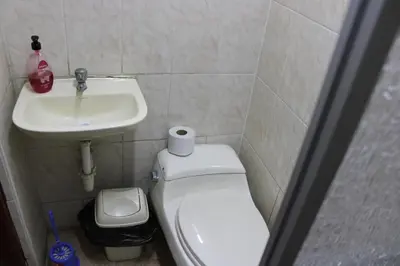 a bathroom with a white toilet and a sink at Hospedaje San Isidro in Lima