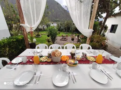 a white table with food on top of it at The Willow B&B in Urubamba