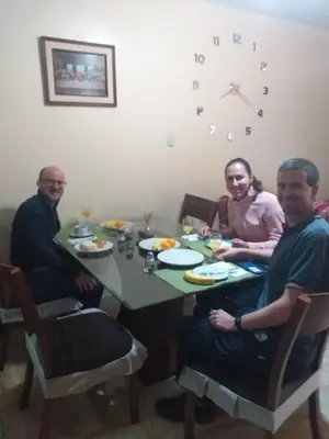 a group of three people sitting around a table at Chakana Family Home 2 Lima Airport in Lima
