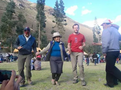 a group of people walking in a field at New Experiences Valle sagrado in Urubamba