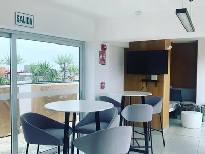 a restaurant with two tables and chairs and a window at MLA apartments - Reducto 360 in Lima