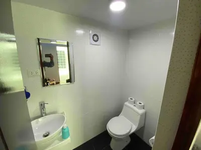 a bathroom with a toilet and a sink and a mirror at Loft en centro histórico Cusco Inlove in Cusco