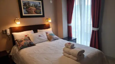 a bedroom with a bed with towels on it at Kametza Hotel Ayacucho in Ayacucho