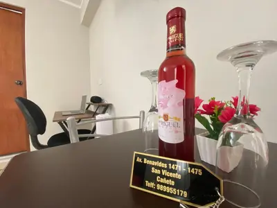 a bottle of wine sitting on top of a table at Residencia Benavides in San Vicente de Cañete