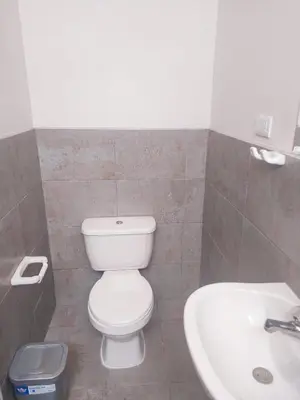 a bathroom with a toilet and a sink at Residencia Benavides in San Vicente de Cañete