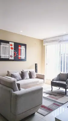 a living room with a couch and a chair at Apartamento JATUN MAMA in Chancay
