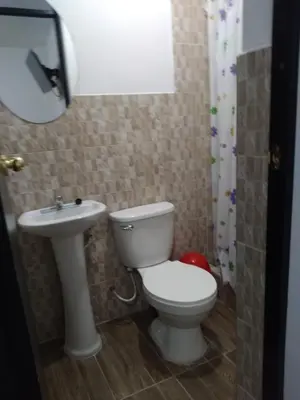 a bathroom with a toilet and a sink at La Petite Maison in Nazca