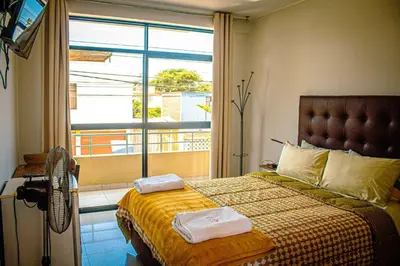 a bedroom with a bed with two towels on it at DEL VALLE HOUSE II in Ica