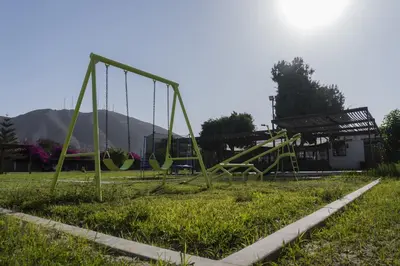 an empty playground in a park with a swing at Casa Solaris in Ica