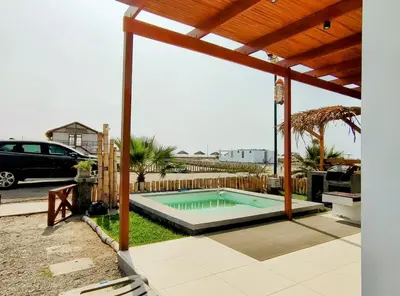 a swimming pool in a backyard with a pergola at Playa ChinchaHouse - Agradable casa de playa en Chinchaycamac in Chincha Baja