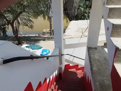 a staircase leading up to a building with a view of the ocean at Hotel Duna Sur in Laguna Huacachina