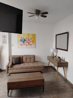 a living room with a couch and a table at Casa Yuraq Hotel Boutique in Chincha Alta