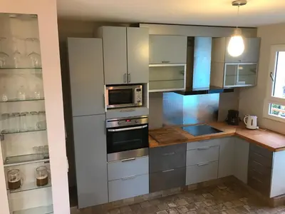 a kitchen with white cabinets and a stove top oven at Loft grande cerca al Olivar en San isidro-Lima in Lima