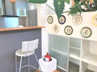 a kitchen with a white chair and plates on the wall at Loft grande cerca al Olivar en San isidro-Lima in Lima