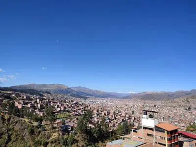 a view of a city with mountains in the background at linda house cusco in Cusco